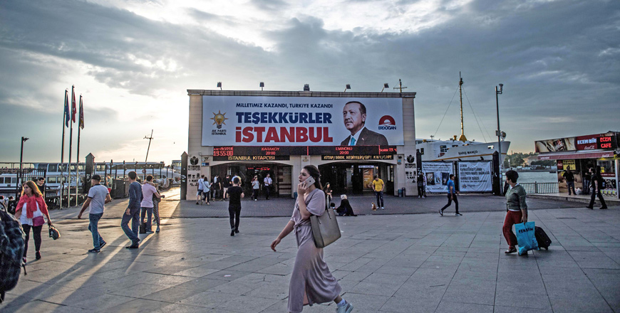 Pedestrians walk past a poster with a photograph of the Turkish president on which ‘Thank you Istanbul’ is written at the Kadikoy Square, in Istanbul, on Thursday (AFP photo)  
