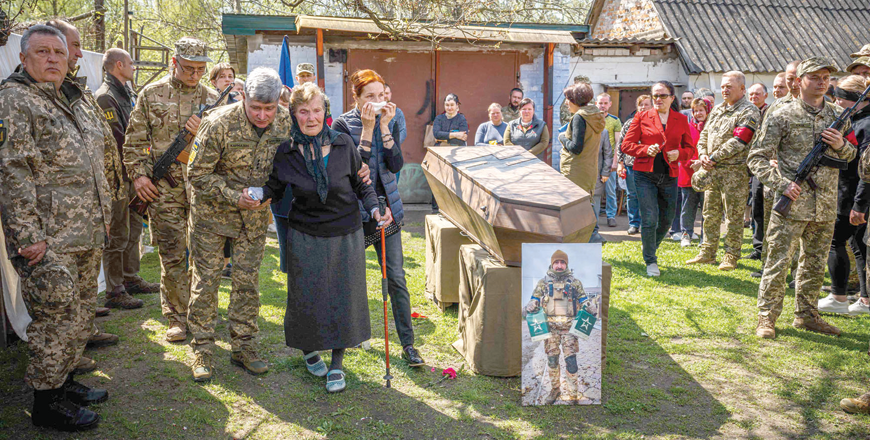Relatives and fellow servicemen attend a funeral ceremony of late Ukrainian serviceman of Azov regiment Yegor Bartosh at his home in the village of Korniivka, Kyiv region on Tuesday, amid the Russian invasion of Ukraine (AFP photo)