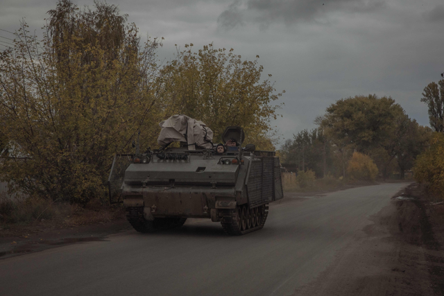 Ukrainian servicemen ride an armoured military vehicle on a road in the Donetsk region, on October 16, 2024 (AFP photo)