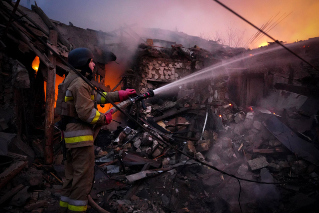 In this handout photograph taken and released by the Ukrainian Emergency Service on November 17, 2024, a Ukrainian rescuer works to extinguish a fire in a building following a drone attack in Mykolaiv (AFP photo)