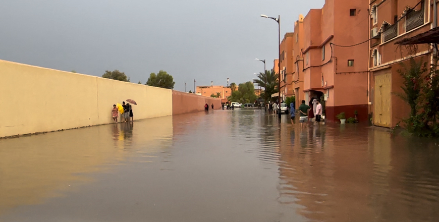 Residents walk on a flooded street in Morocco's Ouarzazate city on Saturday (AFP photo)