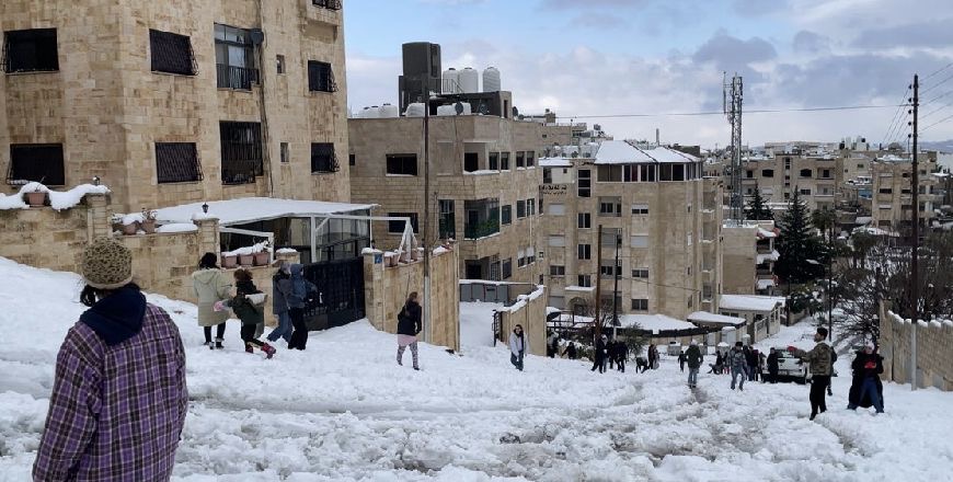 People are seen enjoying snow in an Amman neighbourhood on Thursday (Photo by Tom Grant)
