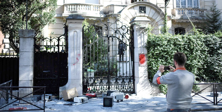 A French security officer takes a photograph outside the Iranian embassy in the French capital Paris on Friday (AFP photo)