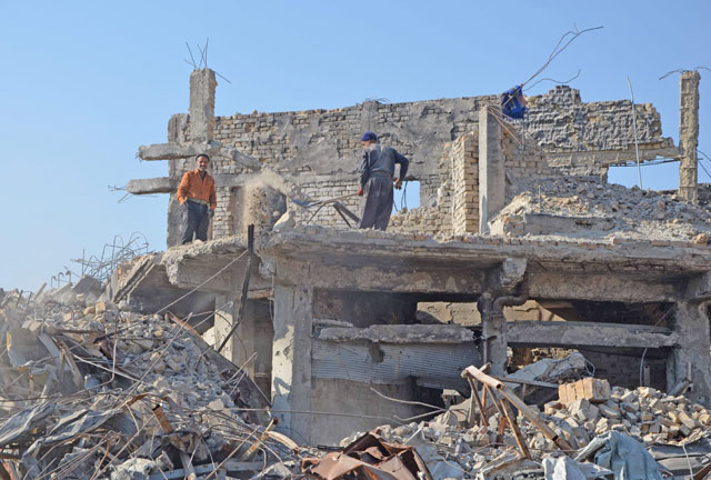 This photo taken on December 16 shows Iraqi volunteers salvaging and cleaning up the debris and destruction in Bab Al Saray area in the old city of the northern Iraqi city of Mosul (AFP photo)