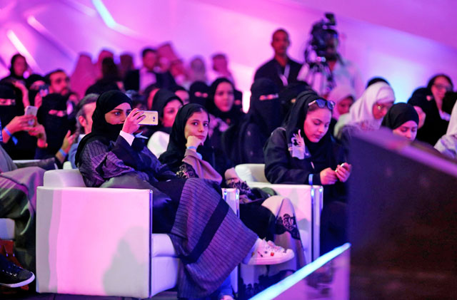 People attend the performance of the actor John Travolta at APEX Convention Centre in Riyadh, Saudi Arabia, on Friday (AFP photo)