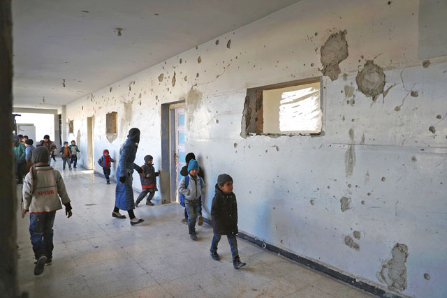 Syrian students and a teacher take part in a training from the Syrian Arab Red Crescent in evacuation procedures for an emergency event at a school in the rebel-controlled village of Utaya, in the eastern Ghouta region on the outskirts of the capital Damascus, on Wednesday (AFP photo)