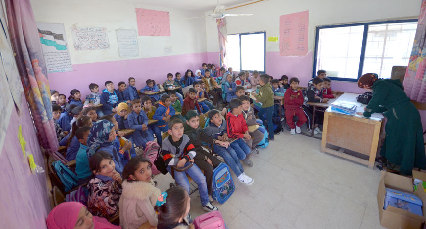 Syrian children attend a class held during the night-shift period at Asma Bint Abi Baker School, in the northern village of Zaatari recently (Photo by Muath Freij)