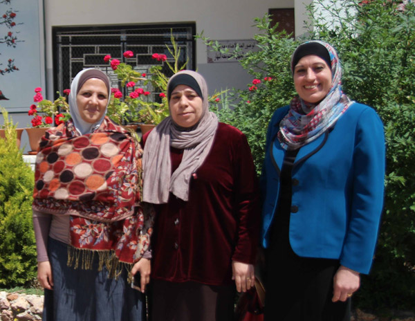 Rana Al Shraydeh, EMIS officer, Safa Al Rabee, school principal and Kholoud Shaawatah, director of planning for Irbid Governorate, pose in front of Al Husn Secondary School for Girls  (Photo courtesy of the UNESCO)