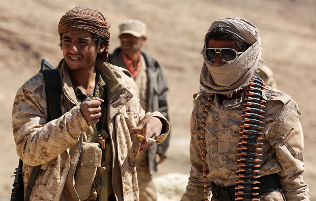 Yemeni tribesmen from the Popular Resistance Committees, who support forces loyal to the Saudi-backed Yemen president, rest as they guard a post in the Nihm district, on the eastern edges of the capital Sanaa, on Friday (AFP photo)