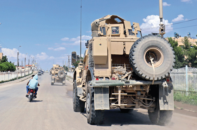 Vehicles from the US-led coalition battling the Daesh militant group patrol the town of Rmelane in Syria's Hasakeh province on June 5 (AFP photo)