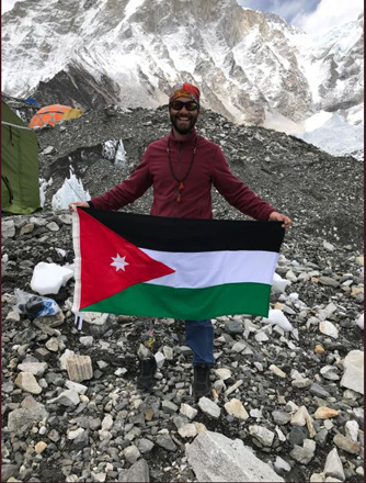 Twenty-year-old Jordanian Jarrah Al Hawamdeh holds the national banner at the Mount Everest base camp on Monday (Photo courtesy of Jarah Al Hawamdeh Twitter page)