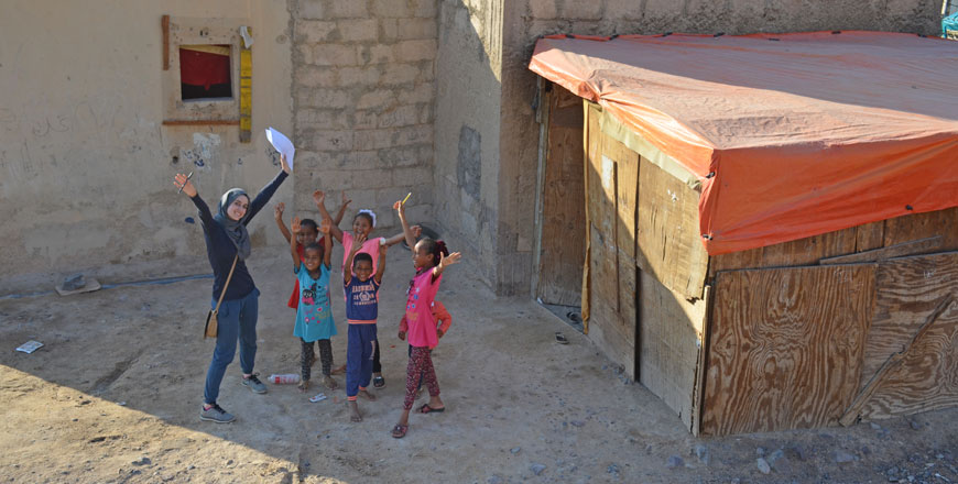 A volunteer with the Green Affordable Homes project reacts with children as they are photographed in Amman recently. The project helps build green affordable houses and retrofit homes for better energy and water efficiency across the Kingdom (Photo courtesy of Jordan GBC)
