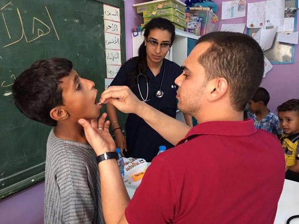 In this undated photo, Syrian refugees receive healthcare services in Jordan  (File photo)