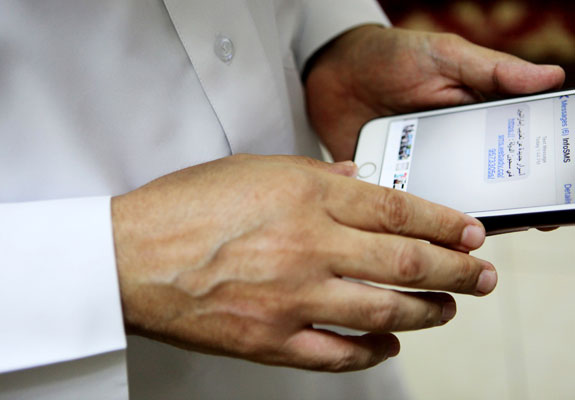 Human rights activist Ahmed Mansoor shows text message he received in the UAE on Thursday. Mansoor was recently targeted by an Israeli spyware that can hack into Apple's iPhone handset  (AP photo by Jon Gambrell)