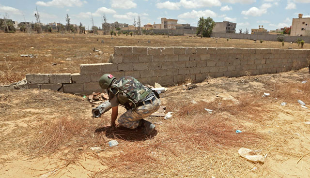 A Turkish deminer takes part in the clearance of unexploded ordnance remaining in the Salah Al Din area, south of the Libyan capital Tripoli, on Monday (AFP photo)