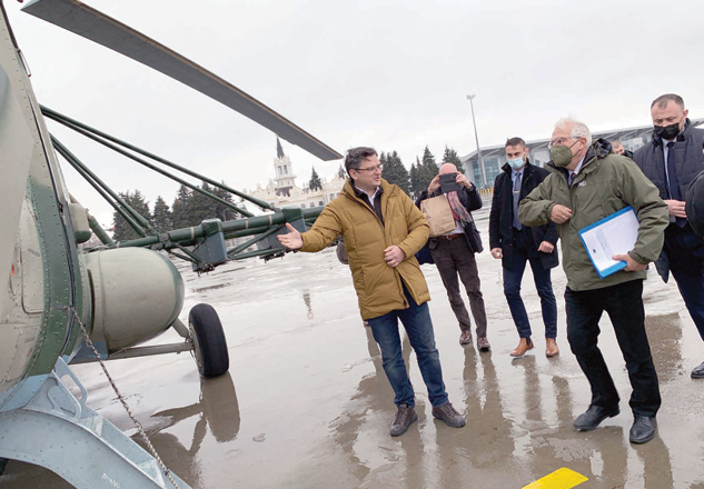 This handout photo taken and released by the Ukrainian ministry of foreign affairs press service, on Wednesday, shows Ukrainian Foreign Affairs Minister Dmytro Kuleba (left) inviting to a helicopter High Representative of the European Union for Foreign Affairs and Security Policy Josep Borrell (2nd right) at Kharkiv International Airport in Kharkiv, prior to their flight to the frontline of Kiev's conflict with pro-Russia rebels in the east of the country (Photo by Ukrainian Foreign Affairs Press-Service/AFP)