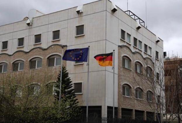 The German and European flags fly in front of the newly reopened German embassy in Damascus on March 20, 2025 (AFP photo)