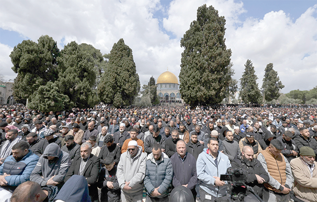 Palestinians perform the second Friday prayer of the Muslim holy fasting month of Ramadan in front of the Dome of the Rock Mosque at Al Aqsa Mosque Complex in Jerusalem on Friday (AFP photo)