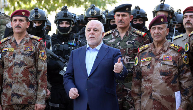 This file handout photo released by the Iraqi Prime Minister Haider Abadi’s office on July 9, 2016 shows him (centre) posing for a picture with army generals and members of the counter-terrorism forces in the capital Baghdad (AFP photo)