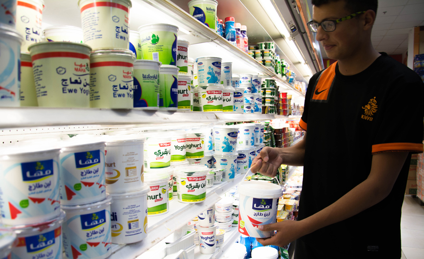 A consumer shops for yoghurt at a supermarket in Amman on Tuesday (Photo by Amjad Ghsoun)
