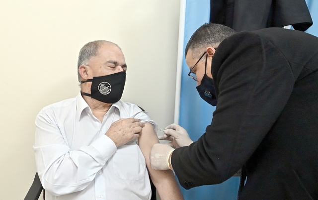 In this photo taken on Wednesday, a man is seen taking a COVID-19 jab in a vaccination centre in Amman (Photo by Amjad Ghsoun)