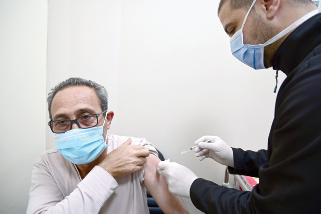 A nurse administers a dose of AstraZeneca COVID vaccine to a man at Prince Hamzeh Hospital’s vaccination centre in Amman in this recent photo (Photo by Amjad Ghsoun)