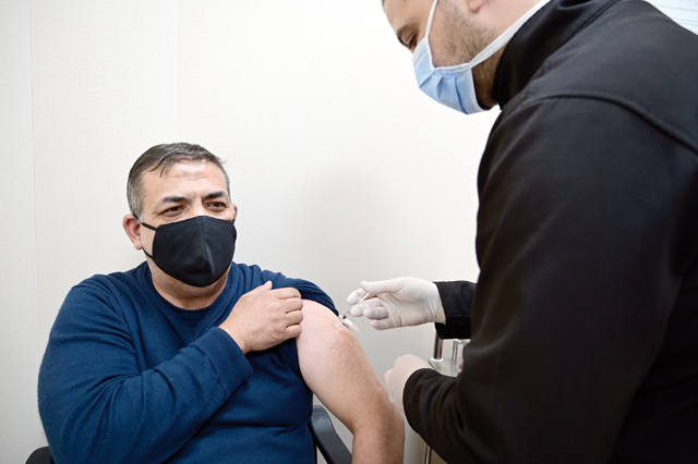 A nurse administers a dose of AstraZeneca COVID vaccine to a man at Prince Hamzeh Hospital’s vaccination centre in Amman on Monday (Photo by Amjad Ghsoun)