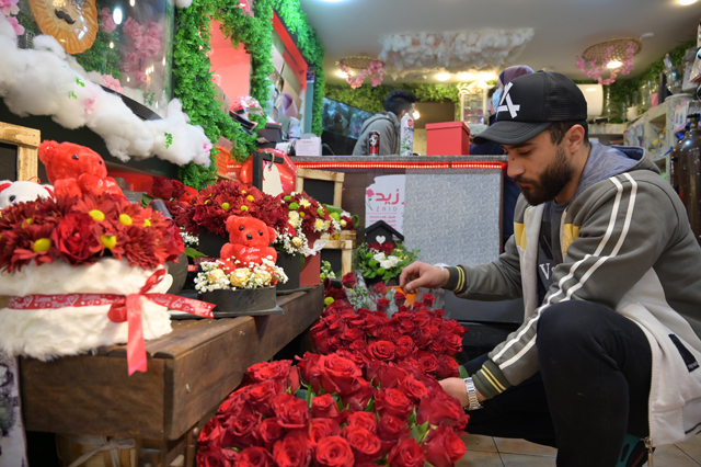 A florist is seen preparing flowers at a shop in Amman ahead of Valentine's Day on Sunday (Photo by Amjad Ghsoun)