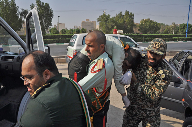 Iranian soldier carrying an injured comrade at the scene of an attack on a military parade on Saturday  in the south-western Iranian city of Ahvaz marking the anniversary of the outbreak of its devastating 1980-1988 war with Saddam Hussein’s Iraq (AFP photo)