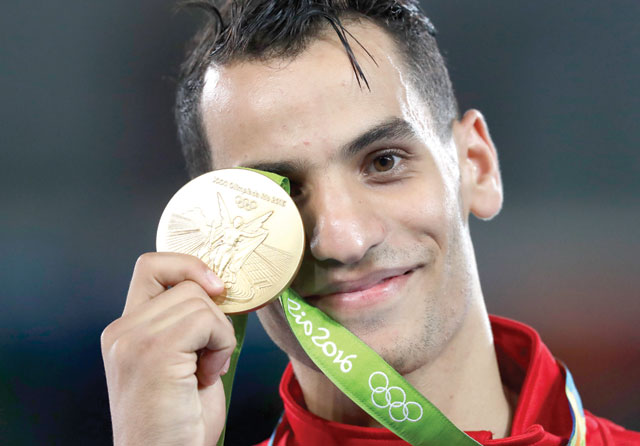 Ahmad Abu Ghaush shows off his gold medal in the men's -68kg taekwondo competition at the 2016 Summer Olympics in Rio de Janeiro, Brazil, on Thursday/Friday Amman time  (AP photo)