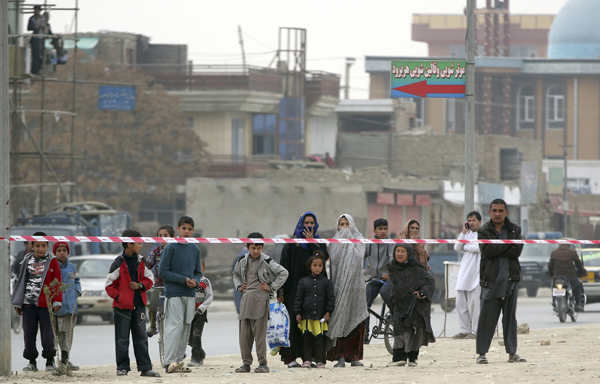  Afghans gather near the Shiite Baqir-ul Ulom Mosque after a suicide attack inside it, in Kabul, Afghanistan, on Monday (AP photo )