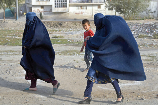 Burqa-clad women walk through the Chaman-e-Shuhada Park in Kabul, on Friday (AFP photo)