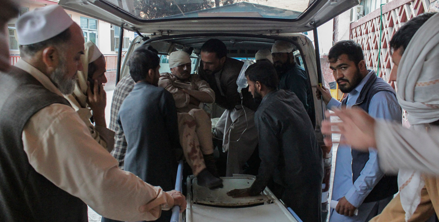 Afghan volunteers help place a wounded man on a stretcher at a hospital after he was injured in a bomb explosion at a mosque in Jalalabad on Friday (AFP photo)