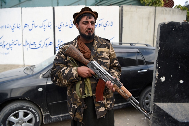 A Taliban fighter guards along a roadside in Jalalabad on Sunday (AFP photo)
