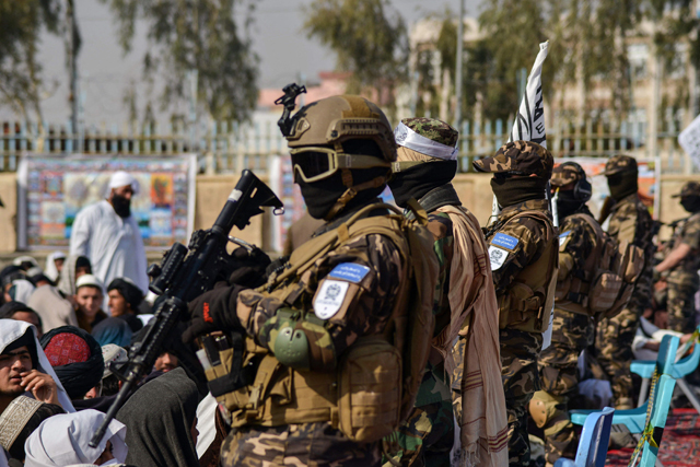 Members of the Taliban Badri 313 military unit stand guard as newly recruited Taliban members who graduated from the Islamic Javadiya Madrassa or Islamic school attend a ceremony in Kandahar on Tuesday (AFP photo)