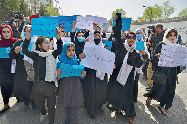 Afghan women and girls take part in a protest in front of the Ministry of Education in Kabul on Saturday, demanding that high schools be reopened for girls (AFP photo)