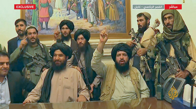 An image grab taken from Qatar-based Al Jazeera television on Monday, shows members of Taliban taking control of the presidential palace in Kabul  (AFP photo)