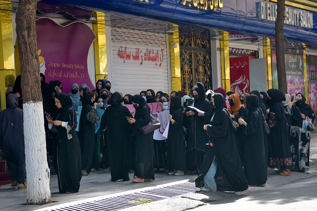 Afghan burqa-clad women stage a protest for their rights at a beauty salon in the Shahr-e-Naw area of Kabul, on Wednesday (AFP photo)