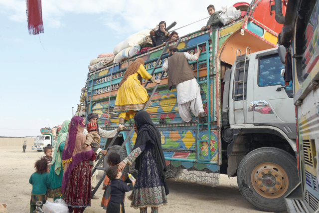 Afghan refugees arrive on a truck to cross the Pakistan-Afghanistan border in Chaman on Wednesday, following Pakistan’s government decision to expel people illegally staying in the country (AFP photo)