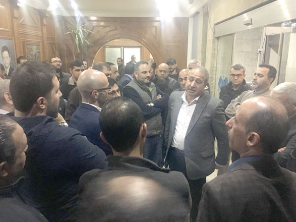 Jordan Press Foundation’s Chairperson Ramadan Rawashdeh (centre) speaks to protesting employees at the premises of the organisation on Wednesday (Photo by Osama Aqarbeh)