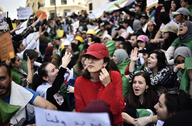 Algerian students chant slogans on Tuesday as they continue their weekly protests in the capital Algiers to demand the overthrow of the ‘system’ (AFP photo)