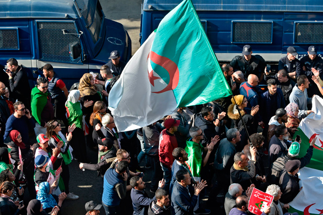 Algerians march in an anti-government demonstration in the capital Algiers on Friday (AFP photo)