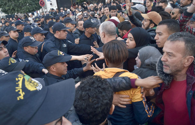 Algerian security forces scuffle with protesters during an anti-government demonstration in the capital Algiers, on Tuesday (AFP photo)