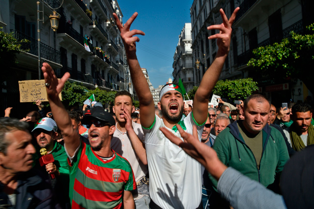 Algerian demonstrators chant slogans during a demonstration in the capital Algiers on Friday (AFP photo)