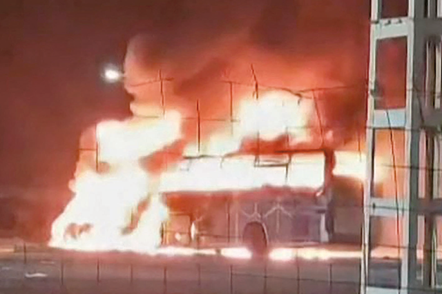 This image grab from a UGC video taken and posted on the Facebook page of Abidine Badion on Wednesday shows a passenger bus bursting into flames after it collided head-on with a commercial vehicle, killing more than 30 people near Tamanrasset in Algeria's southern desert (AFP photo)
