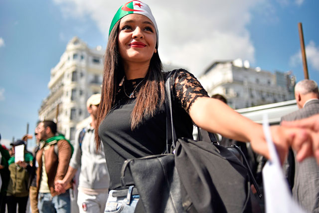 Algerian students raise banners and placards as they take part in a demonstraion against the current government in the capital Algiers on Tuesday (AFP photo)