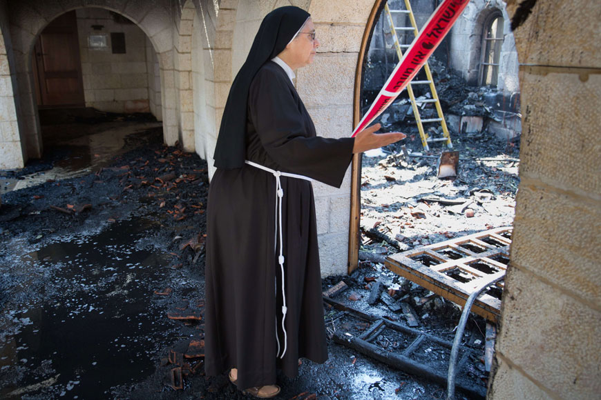A nun inspects the damage at a room located on the complex of the Church of the Multiplication at Tabgha, on the shores of Lake Tiberias in northern Israel, on Thursday, in the aftermath of a suspected arson attack (AFP photo)