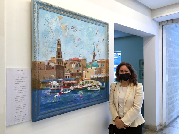 Artist Dalia Ali poses for a photo next to her painting during her exhibition titled ‘Nostalgia of the Heart’ at the Foresight32 Gallery in Amman  (Photo by Margaux Farran)