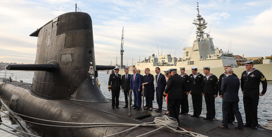 This file photo taken on May 2, 2018 shows French President Emmanuel Macron (second left) and Australian Prime Minister Malcolm Turnbull (third left) standing on the deck of HMAS Waller, a Collins-class submarine operated by the Royal Australian Navy, at Garden Island in Sydney (AFP photo)