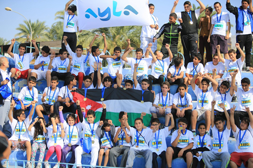 Children celebrate after the 4.2km Children’s Race  of the 2014 Ayla Red Sea Half Marathon (Photo courtesy of Run Jordan)